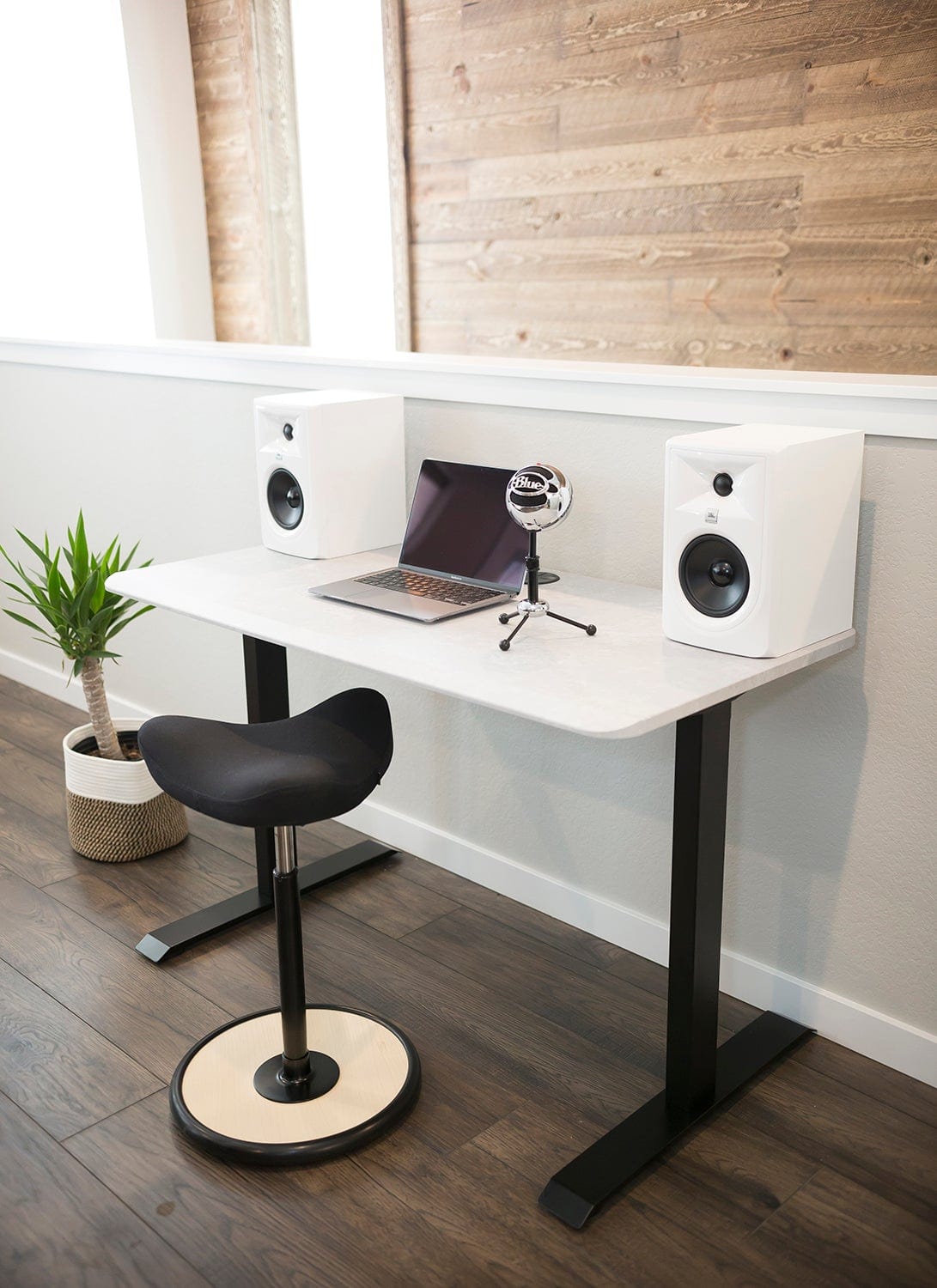 48x24 White Side Table Fixed Height Desk in a home offic with speakers, podcast microphone, laptop, and black stool