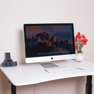 Classic White Desktop Electric Standing Desk shown with iMac iPhone and Flowers